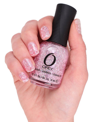 hand holding orange pink topper nail polish bottle