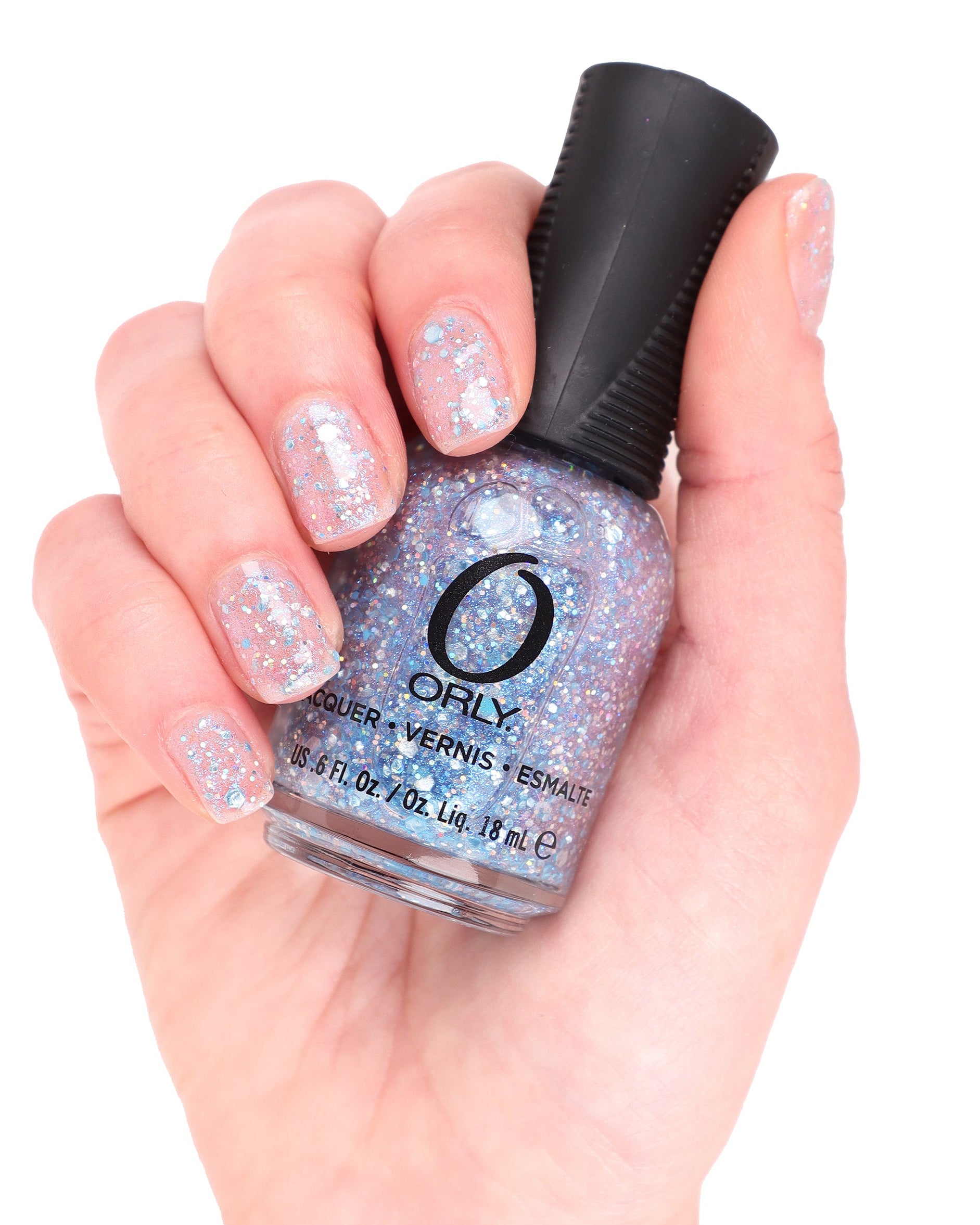 hand holding blue glitter topper nail polish bottle