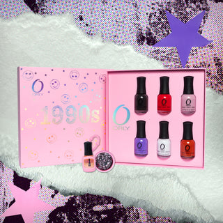 A pink box with holographic smiley faces and text 1990's, 6 nail polish bottles, a mini cuticle oil bottle and pink round container with nail charms